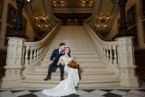 editorial portrait of couple sitting on stairs at One North Broad