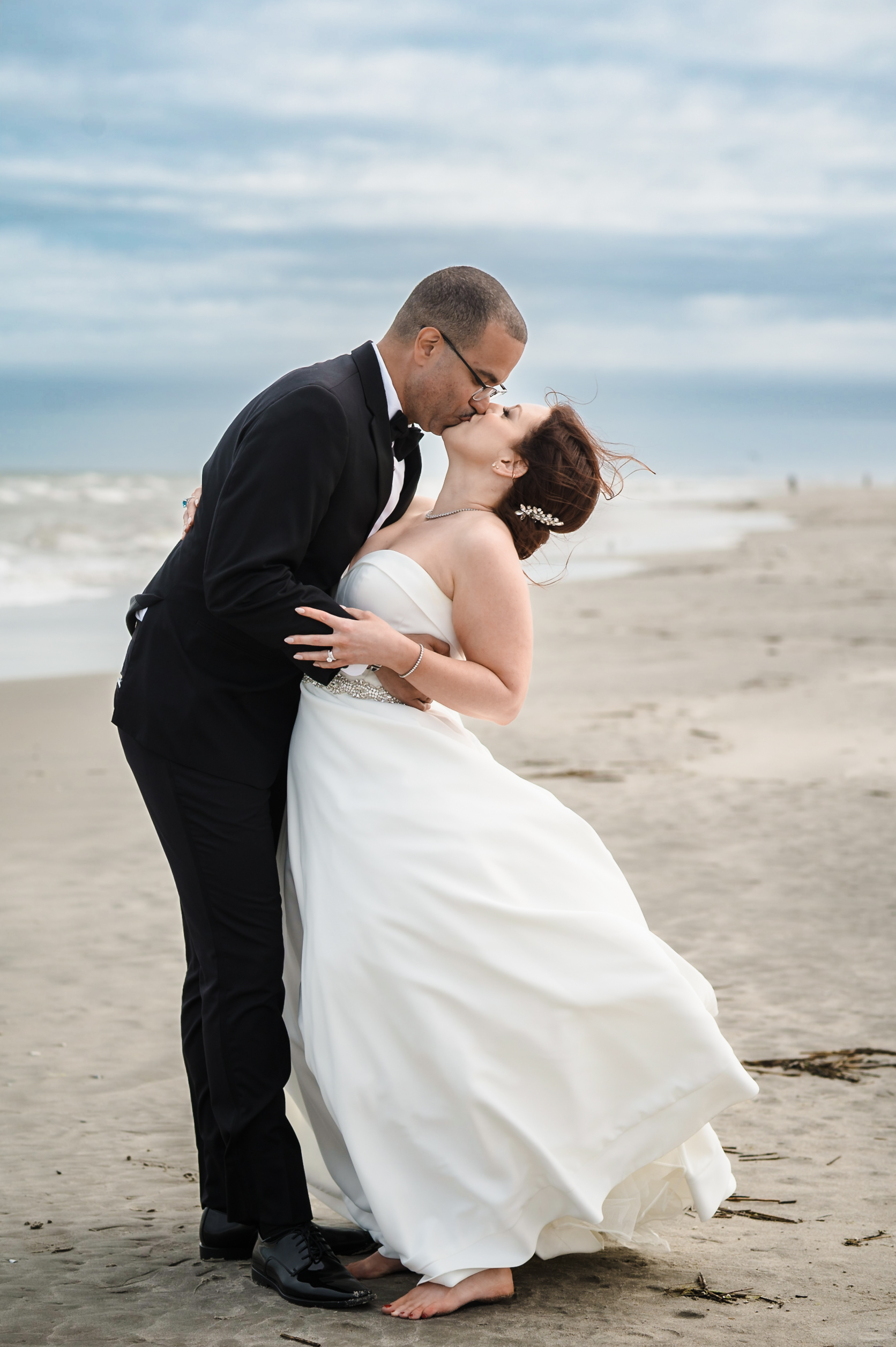 romantic portrait of couple kissing on the beach at ICON
