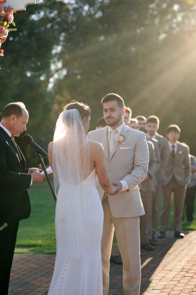 Wedding ceremony with sunlight backdrop at pen ryn mansion.