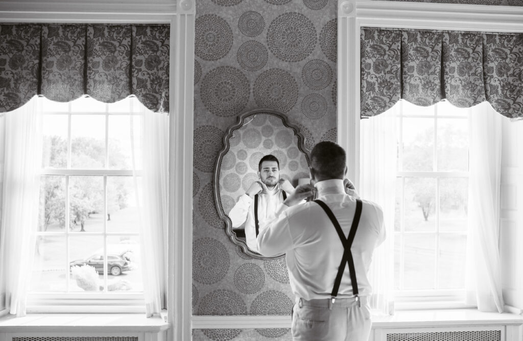 Groom getting ready in groom suite at pen ryn mansion