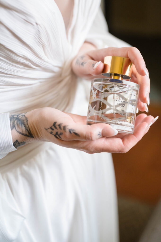 bride holding perfume bottle