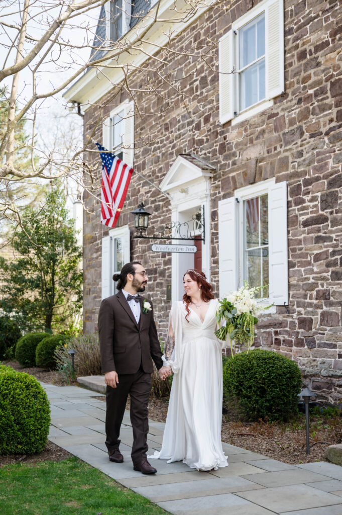 bride and groom walking and smiling at each other at woolverton