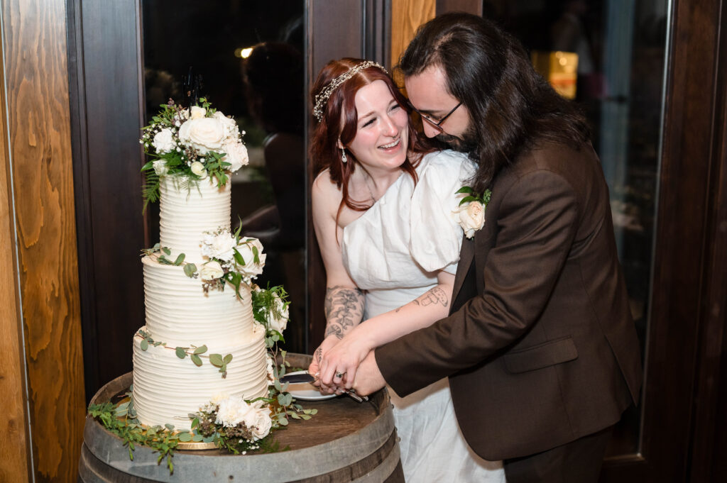 bride and groom cutting their wedding cake at woolverton inn