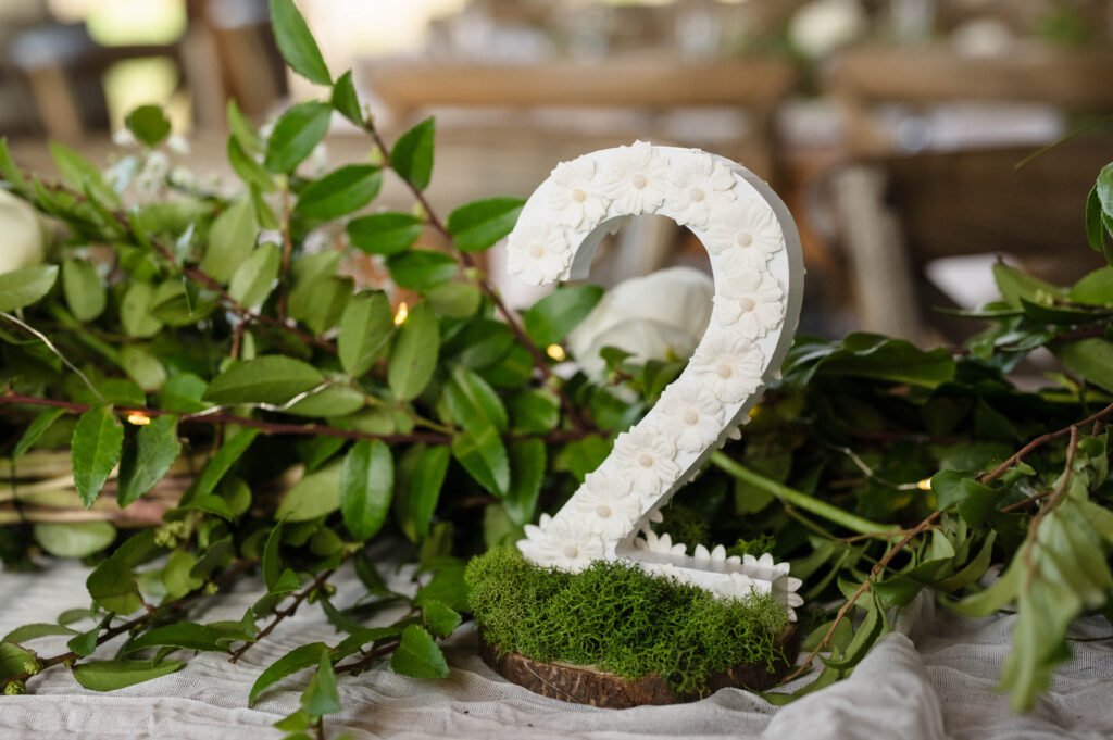 floral table number with moss and daises