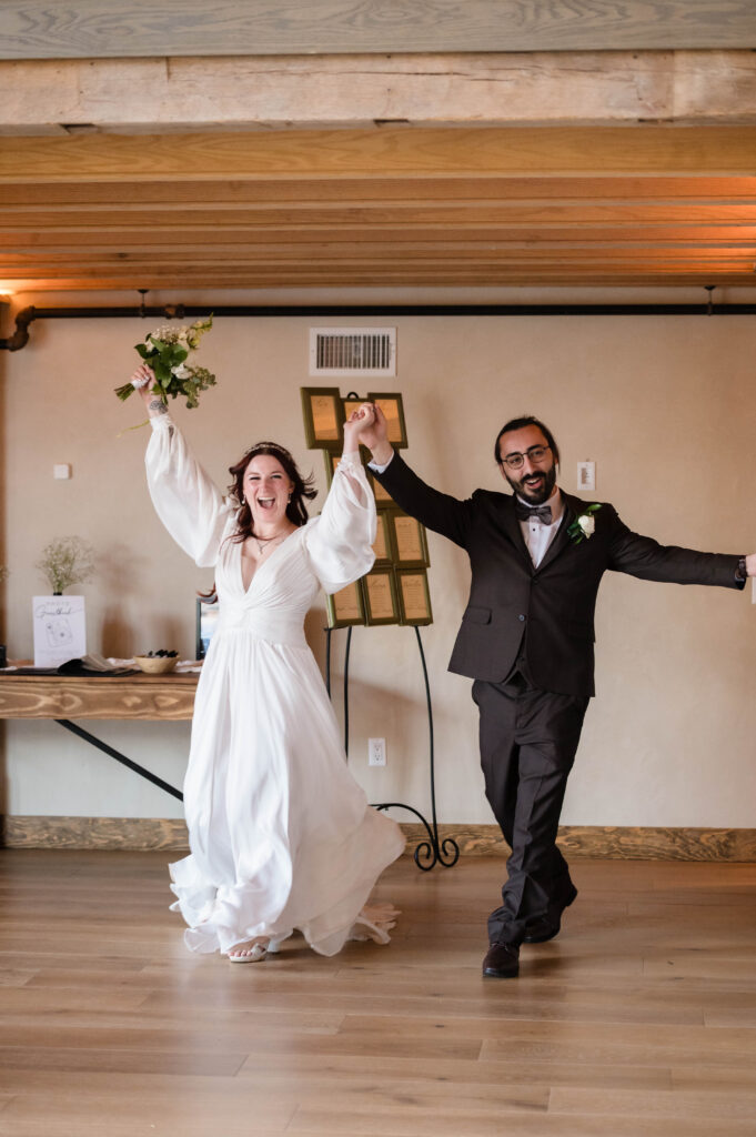 bride and groom walking into reception at woolverton inn
